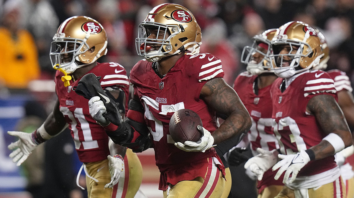 San Francisco 49ers linebacker Dre Greenlaw (57) celebrates his interception during the third quarter of their NFC divisional playoff game