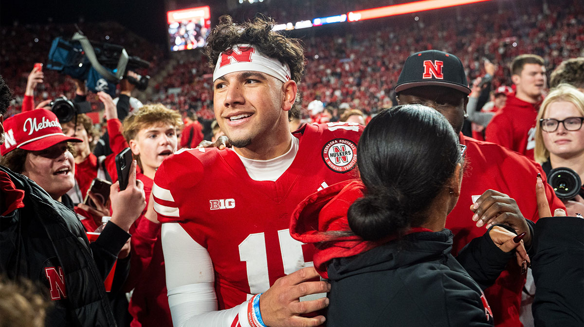 Nebraska Cornhuskers quarterback Dylan Raiola (15) walks off as fans rush the field after defeating the Wisconsin Badgers at Memorial Stadium.