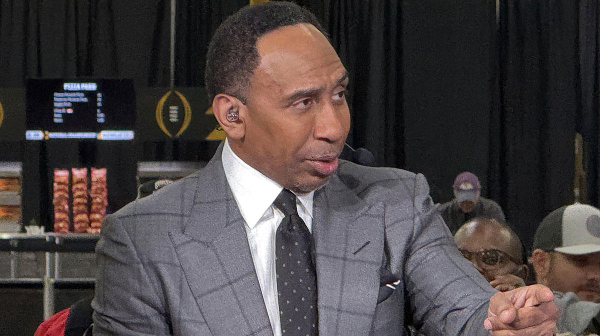 ESPN personality Stephen A. Smith on the ESPN First Take set at the CFP Fan Central at the George World Congress Center next to Suns owner Mat Ishbia and The Ringer's Bill Simmons