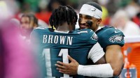 Philadelphia Eagles wide receiver A.J. Brown (11) hugs quarterback Jalen Hurts (1) during the second half of Super Bowl LIX at Caesars Superdome.