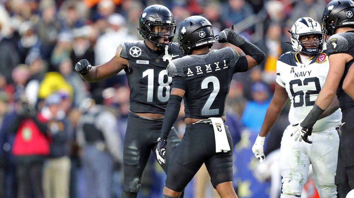 Army Black Knights linebacker Elo Modozie (18) celebrates his college football transfer portal sack with defensive back Chance Keith (2) during the first half of the the 125th Army-Navy game at Northwest Stadium.