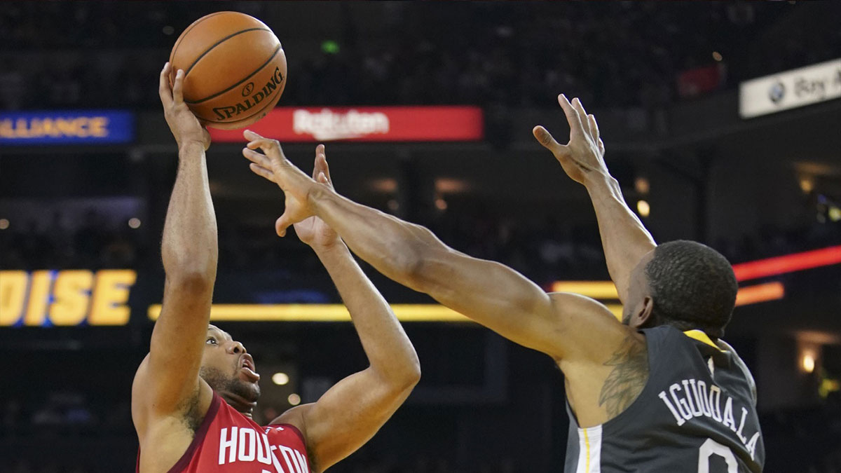 Houston Rockets guard Eric Gordon (10) shoots the basketball against Golden State Warriors guard Andre Iguodala (9) during the second quarter at Oracle Arena.
