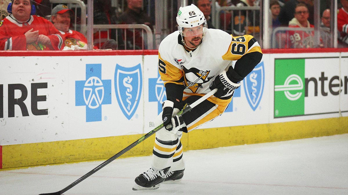 Pittsburgh Penguins defenseman Erik Karlsson (65) clears the puck during the first period against the Chicago Blackhawks at United Center.