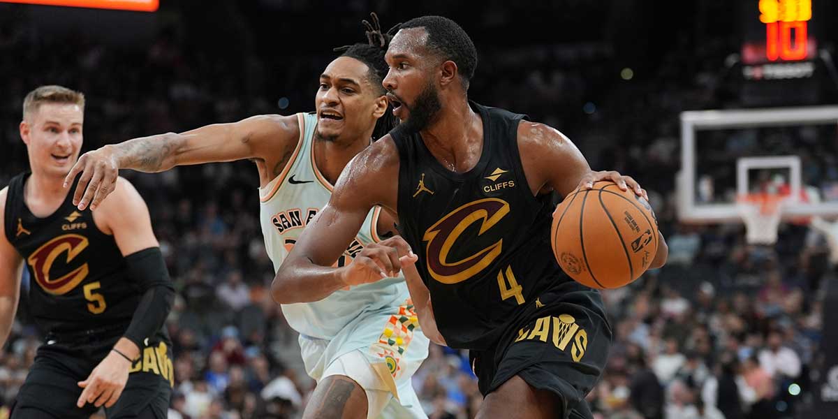 Cleveland Cavaliers forward Evan Mobley (4) dribbles past San Antonio Spurs guard Devin Vassell (24) in the first half at Frost Bank Center.