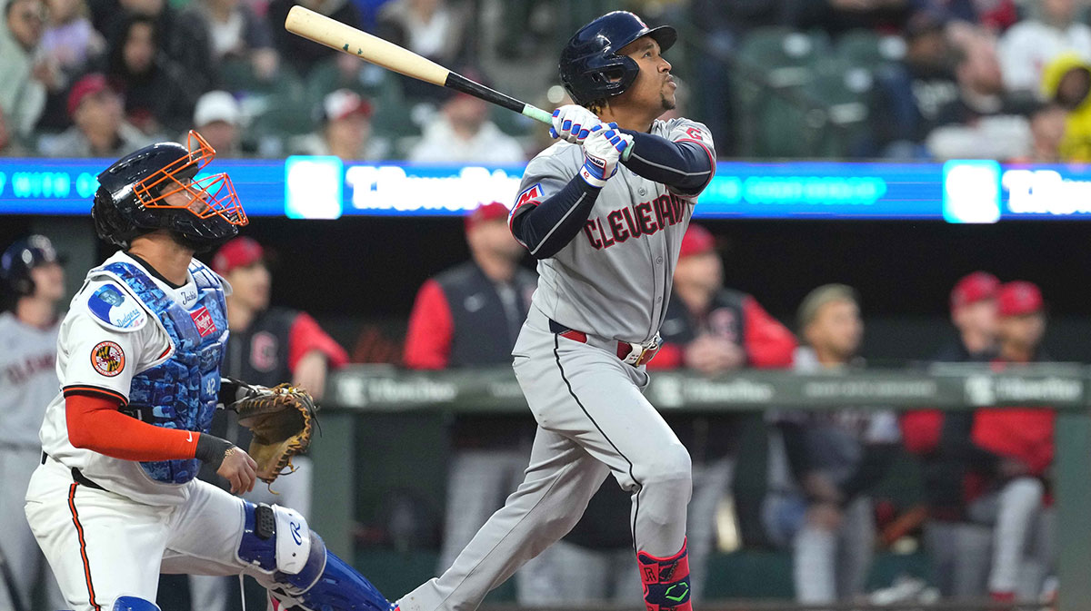 Cleveland Guardians third baseman Jose Ramirez (42) drives in a fourth inning run on a sacrifice fly ball against the Baltimore Orioles at Oriole Park at Camden Yards.