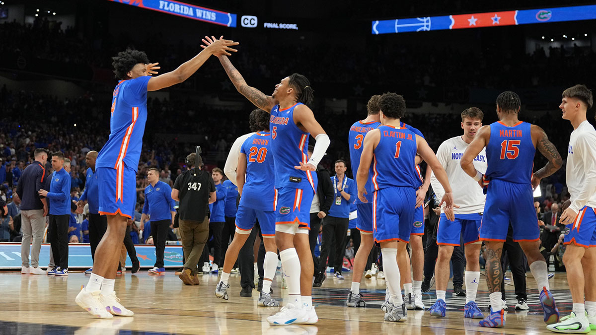Florida Gators players celebrate after defeating the Auburn Tigers in the semifinals of the men's Final Four of the 2025 NCAA Tournament at the Alamodome.