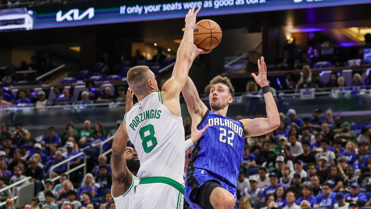 Apr 25, 2025; Orlando, Florida, USA; Orlando Magic forward Franz Wagner (22) shoots against Boston Celtics center Kristaps Porzingis (8) during the second quarter of game three of first round for the 2025 NBA Playoffs at Kia Center.