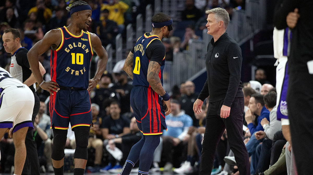 Golden State Warriors head coach Steve Kerr (right) confers with players Jimmy Butler III (10) and Gary Payton II (0) during the second quarter at Chase Center.