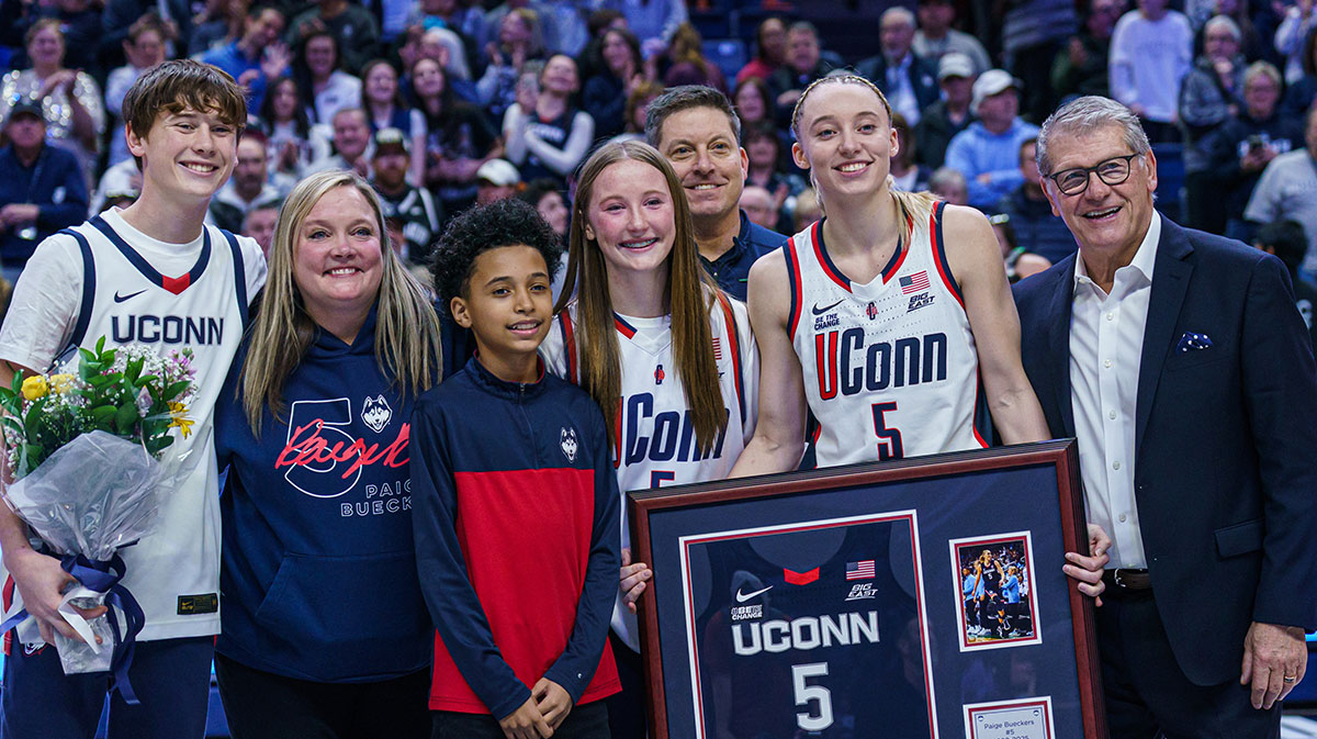 UConn Huskies guard Paige Bueckers (5) is recognized during senior night along side head coach Geno Auriemma and her family after the game against the Marquette Golden Eagles at Harry A. Gampel Pavilion.