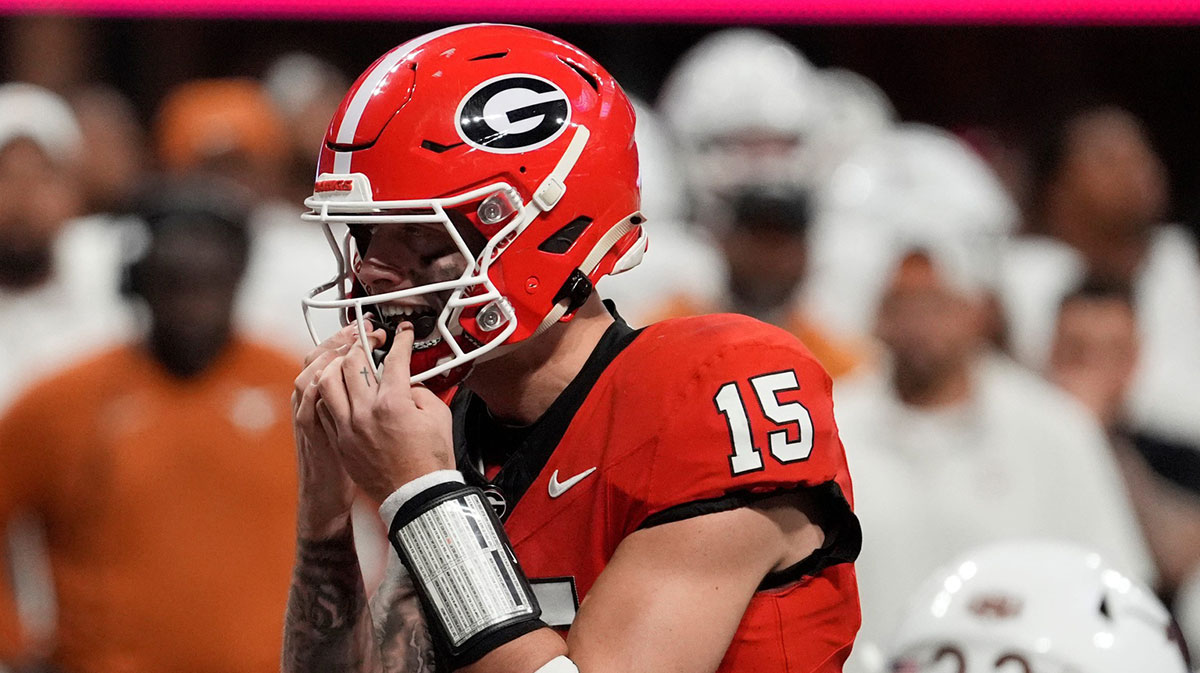 Georgia quarterback Carson Beck (15) putts in his mouth grad on the final play during overtime of the SEC championship game against Texas in Atlanta, on Saturday, Dec. 7, 2024.