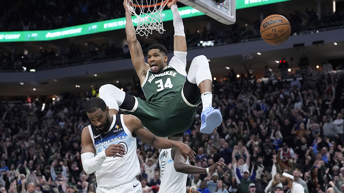 Milwaukee Bucks forward Giannis Antetokounmpo (34) dunks the ball against Minnesota Timberwolves guard Mike Conley (10) in the second half at Fiserv Forum.