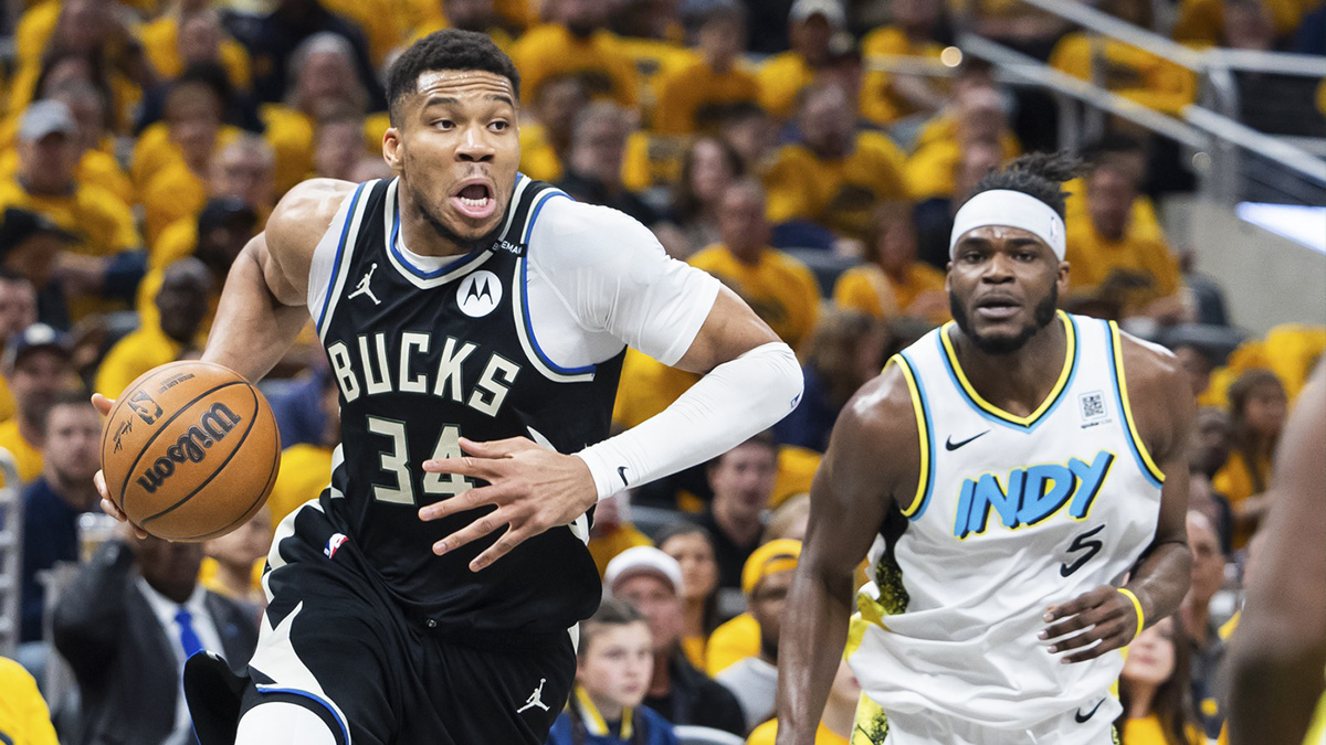 Milwaukee Bucks forward Giannis Antetokounmpo (34) dribbles the ball while Indiana Pacers forward Jarace Walker (5) defends in the first half at Gainbridge Fieldhouse.
