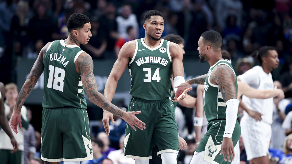 Milwaukee Bucks forward Giannis Antetokounmpo (34) celebrates with Milwaukee Bucks guard Damian Lillard (0) and Milwaukee Bucks forward Kyle Kuzma (18) against the Dallas Mavericks during the first half at American Airlines Center.
