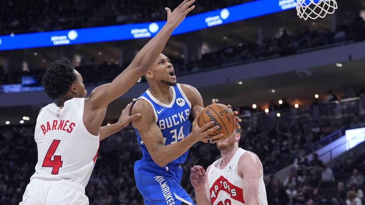 Milwaukee Bucks forward Giannis Antetokounmpo (34) drives to the basket against Toronto Raptors forward Scottie Barnes (4) in the second half at Fiserv Forum.