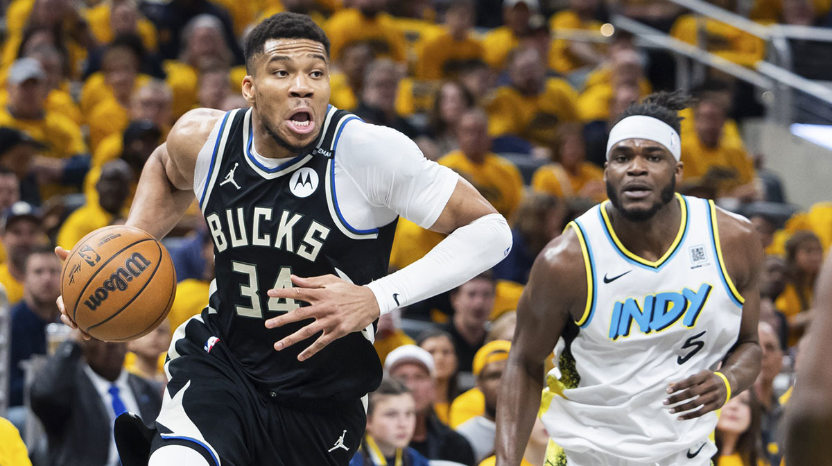 Milwaukee Bucks forward Giannis Antetokounmpo (34) dribbles the ball while Indiana Pacers forward Jarace Walker (5) defends in the first half at Gainbridge Fieldhouse.