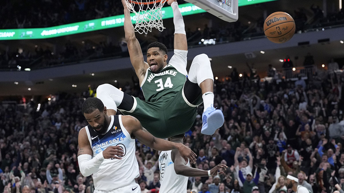 Milwaukee Bucks forward Giannis Antetokounmpo (34) dunks the ball against Minnesota Timberwolves guard Mike Conley (10) in the second half at Fiserv Forum.