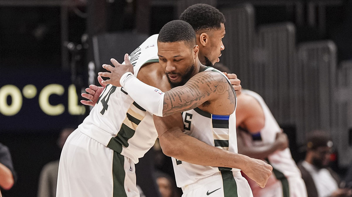 Milwaukee Bucks forward Giannis Antetokounmpo (34) and guard Damian Lillard (0) react after defeating the Atlanta Hawks at State Farm Arena.
