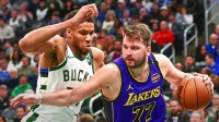 Los Angeles Lakers guard Luka Doncic (77) drives to the basket against Milwaukee Bucks forward Giannis Antetokounmpo (34) in the third quarter at Fiserv Forum.