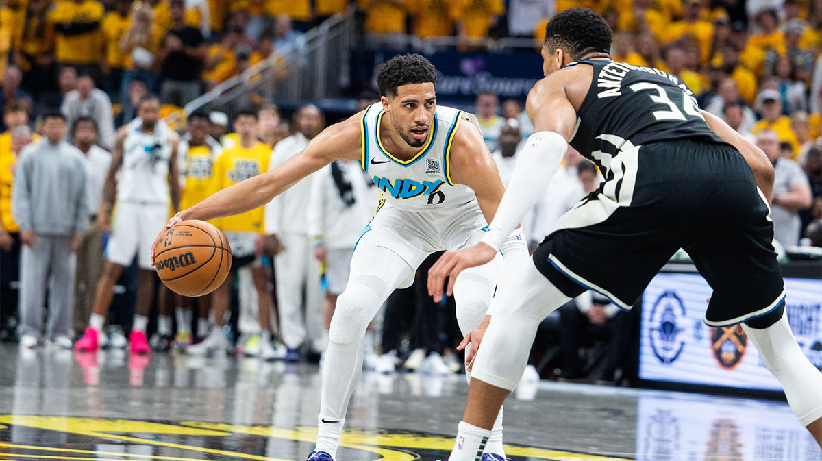 Indiana Pacers guard Tyrese Haliburton (0) dribbles the ball while Milwaukee Bucks forward Giannis Antetokounmpo (34) defends during game five of the first round for the 2024 NBA Playoffs at Gainbridge Fieldhouse.