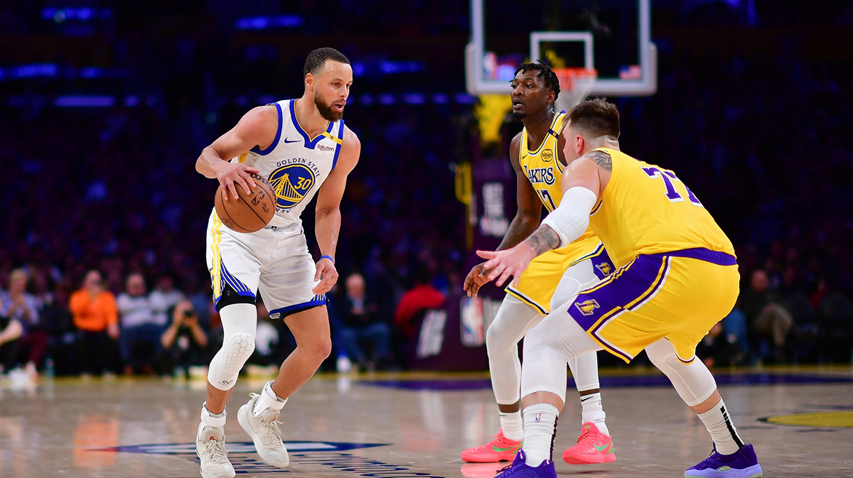 Golden State Warriors guard Stephen Curry (30) controls the ball against Los Angeles Lakers forward Dorian Finney-Smith (17) and guard Luka Doncic (77) during the second half at Crypto.com Arena