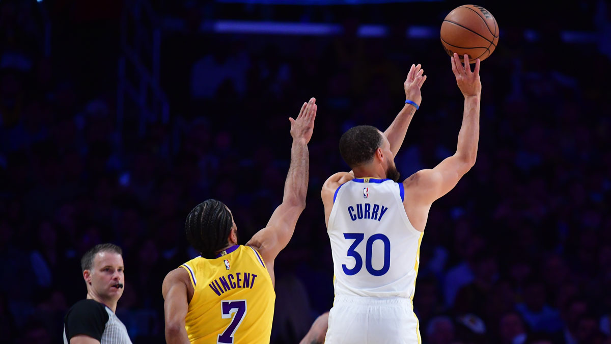 Apr 3, 2025; Los Angeles, California, USA; Golden State Warriors guard Stephen Curry (30) shoots against Los Angeles Lakers guard Gabe Vincent (7) during the first half at Crypto.com Arena. Mandatory Credit: Gary A. Vasquez-Imagn Images