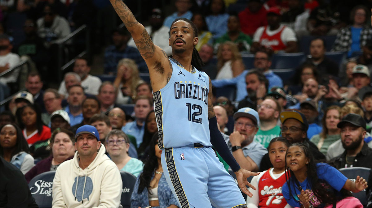 Memphis Grizzlies guard Ja Morant (12) holds after shooting for three during the fourth quarter against the Boston Celtics at FedExForum.