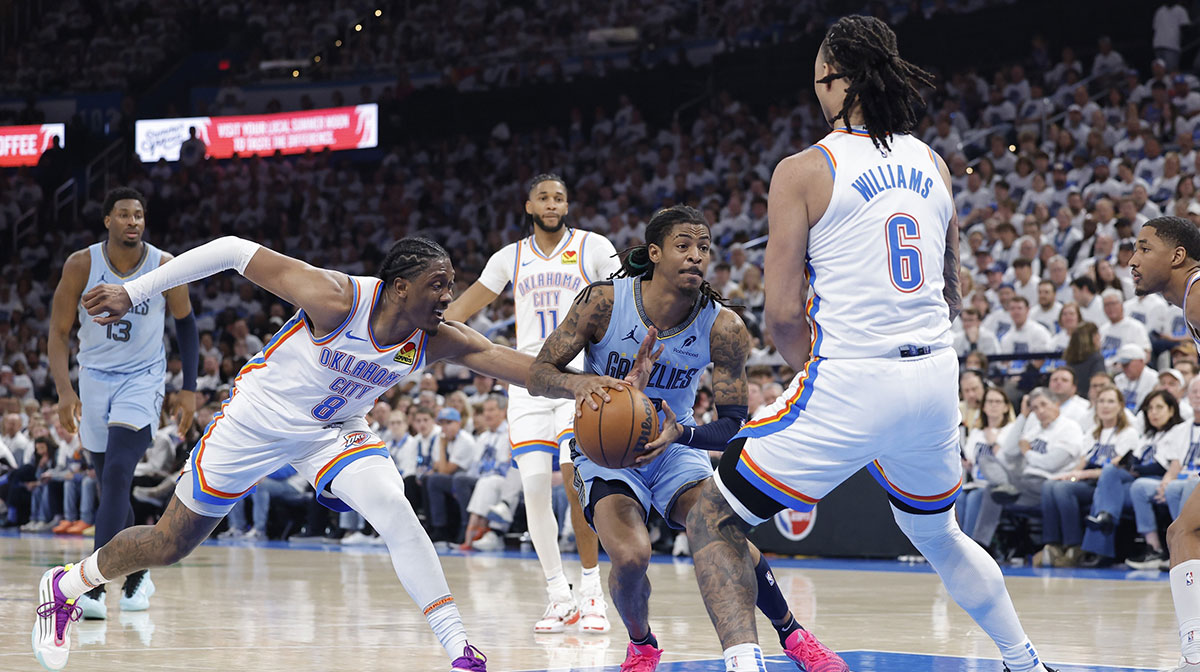 Memphis Grizzlies guard Ja Morant (12) drives to the basket between Oklahoma City Thunder forward Jalen Williams (8) and forward Jaylin Williams (6) during the second half at Paycom Center.