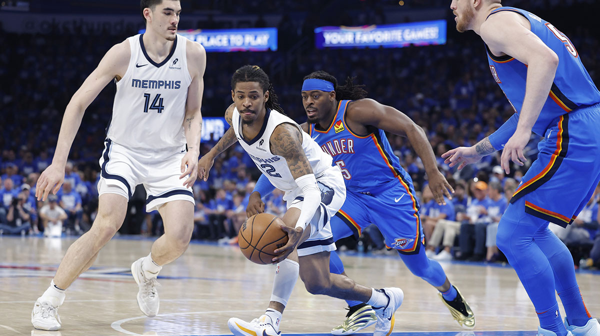 Memphis Grizzlies guard Ja Morant (12) moves the ball around Oklahoma City Thunder guard Luguentz Dort (5) in the third quarter during game two of first round for the 2024 NBA Playoffs at Paycom Center.