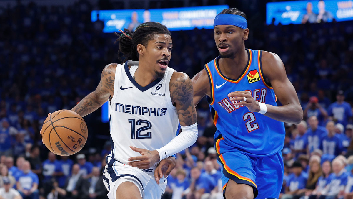 Grizzlies guard Ja Morant (12) drives to the basket beside Oklahoma City Thunder guard Shai Gilgeous-Alexander (2) in the third quarter during game two of first round for the 2024 NBA Playoffs at Paycom Center