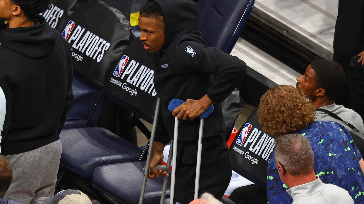 Memphis Grizzlies guard Ja Morant (12) stands by the bench on crutches during the fourth quarter against the Oklahoma City Thunder during game three for the first round of the 2024 NBA Playoffs at FedExForum.