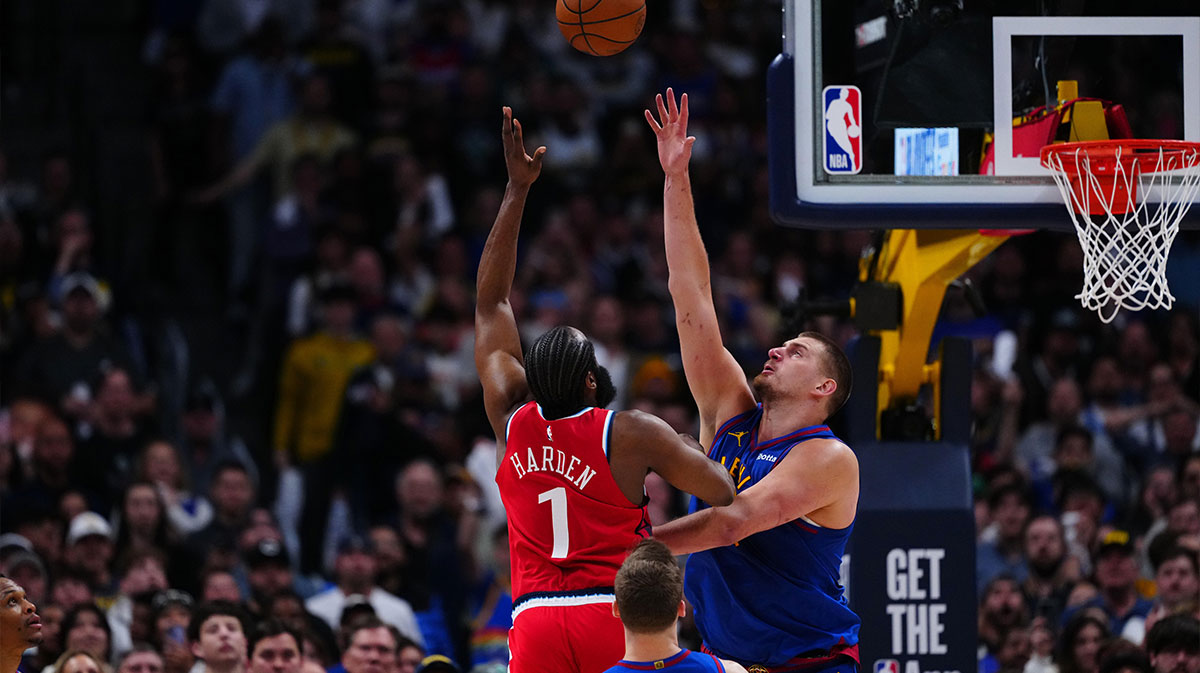 LA Clippers guard James Harden (1) shoots over Denver Nuggets center Nikola Jokic (15) in overtime at Ball Arena