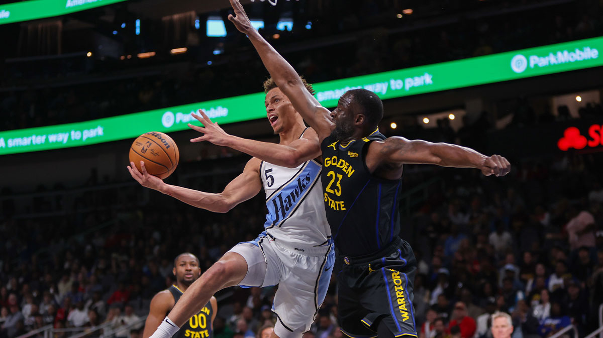 Hawks guard Dyson Daniels (5) shoots past Golden State Warriors forward Draymond Green (23)
