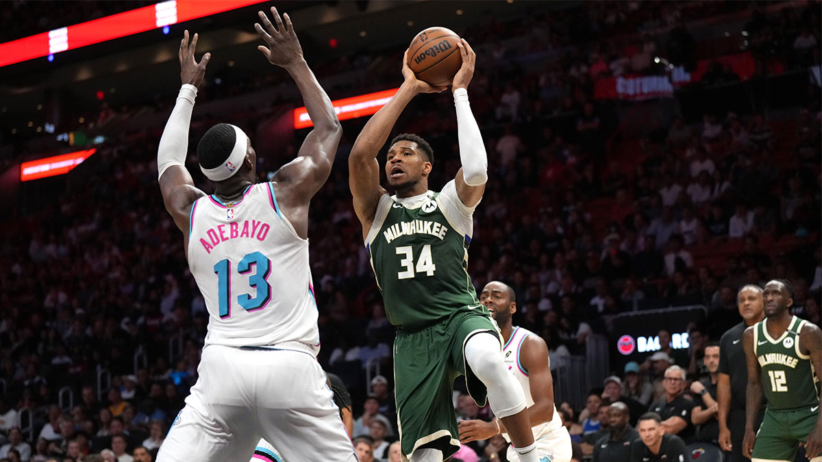 Milwaukee Bucks forward Giannis Antetokounmpo (34) looks to pass the ball as Miami Heat center Bam Adebayo (13) defends during overtime at Kaseya Center. 