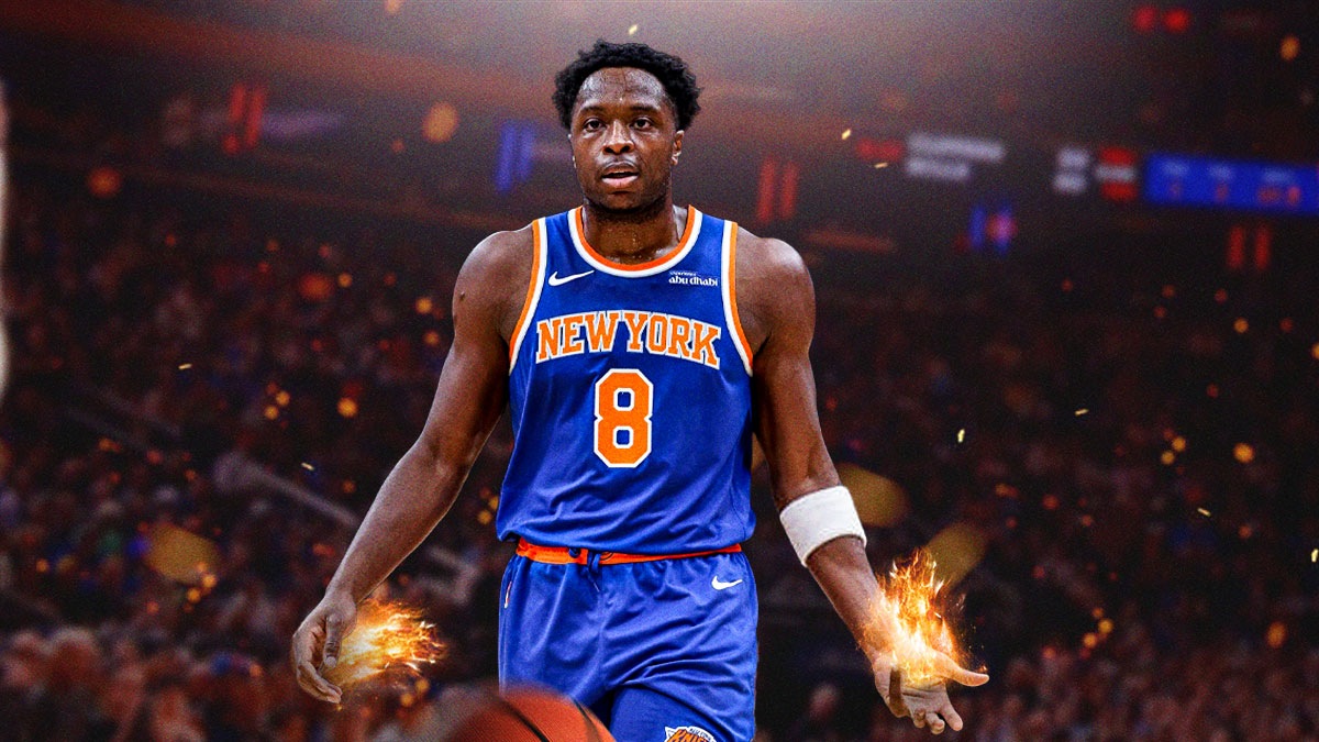 Knicks OG Anunoby with Madison Square Garden behind him. Anunoby's hands are both on fire