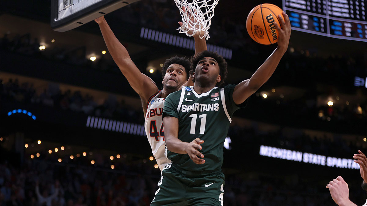 Michigan State Spartans guard Jase Richardson (11) shoots against Auburn Tigers center Dylan Cardwell (44) during the second half in the South Regional final of the 2025 NCAA tournament at State Farm Arena.