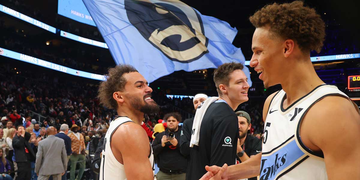 Atlanta Hawks guard Trae Young (11) celebrates with guard Dyson Daniels (5) after an overtime victory over the Los Angeles Lakers at State Farm Arena.
