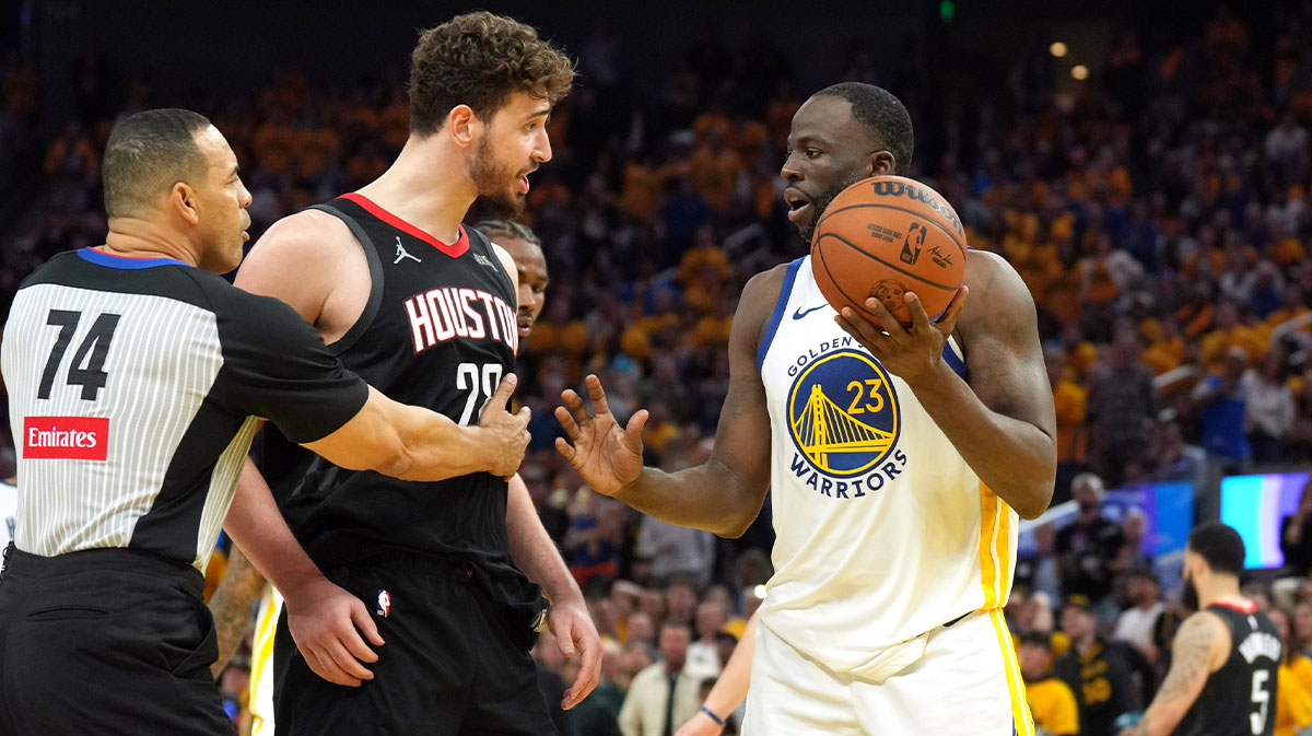 Houston Rockets center Alperen Sengun (center left) and Golden State Warriors forward Draymond Green (23) argue as referee Curtis Blair (74) intervenes during the fourth quarter of game three of first round for the 2024 NBA Playoffs at Chase Center.