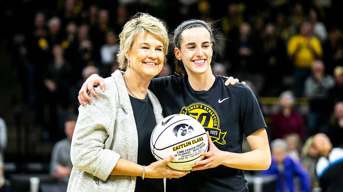 Iowa head coach Lisa Bluder, left, poses for a photo with then-Iowa and now-Indiana Fever guard Caitlin Clark (22) before a NCAA Big Ten Conference women's basketball game against Purdue at Carver-Hawkeye Arena in Iowa City, Iowa.