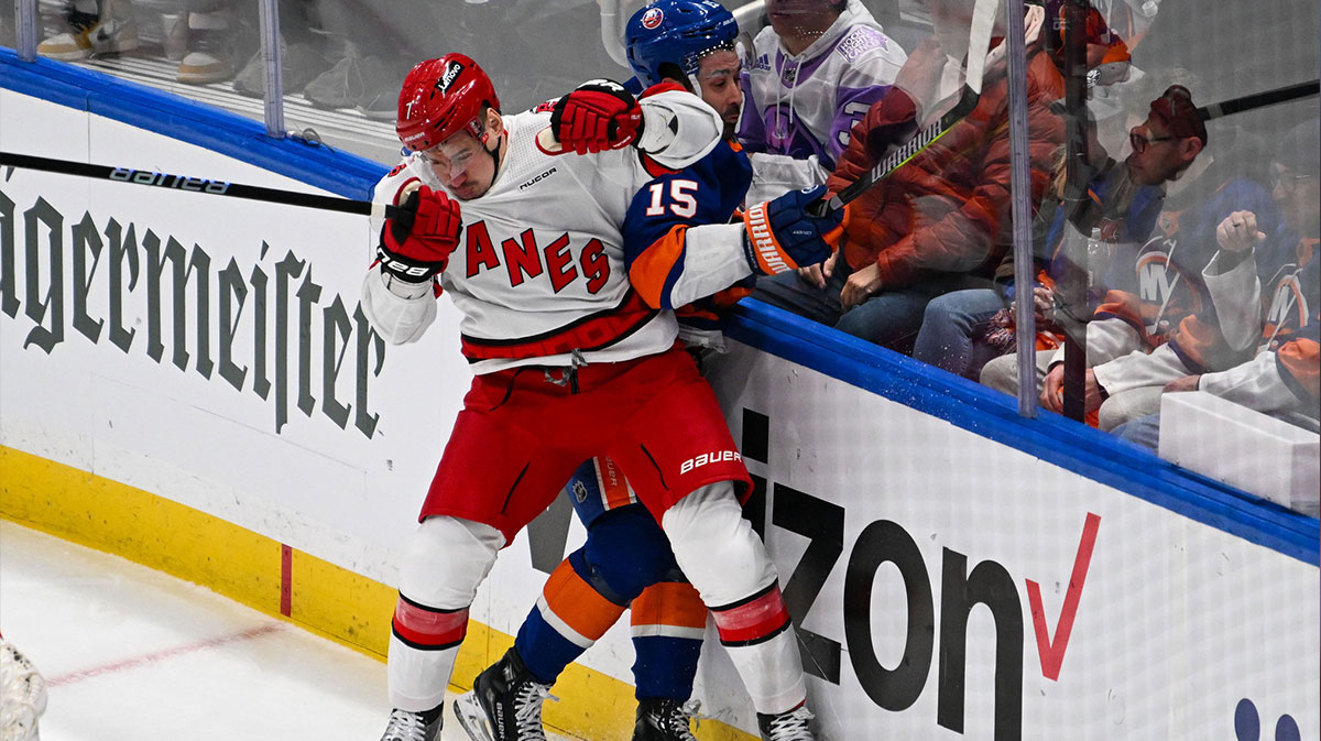 Carolina Hurricanes defenseman Dmitry Orlov (7) checks New York Islanders right wing Cal Clutterbuck (15) during the first period in game three of the first round of the 2024 Stanley Cup Playoffs at UBS Arena