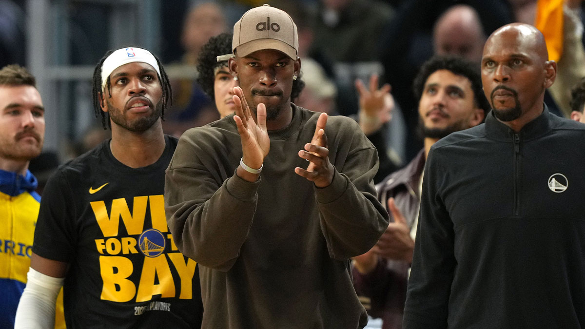 Golden State Warriors forward Jimmy Butler III (center) applauds from the bench against the Houston Rockets during the third quarter of game three of first round for the 2024 NBA Playoffs at Chase Center.