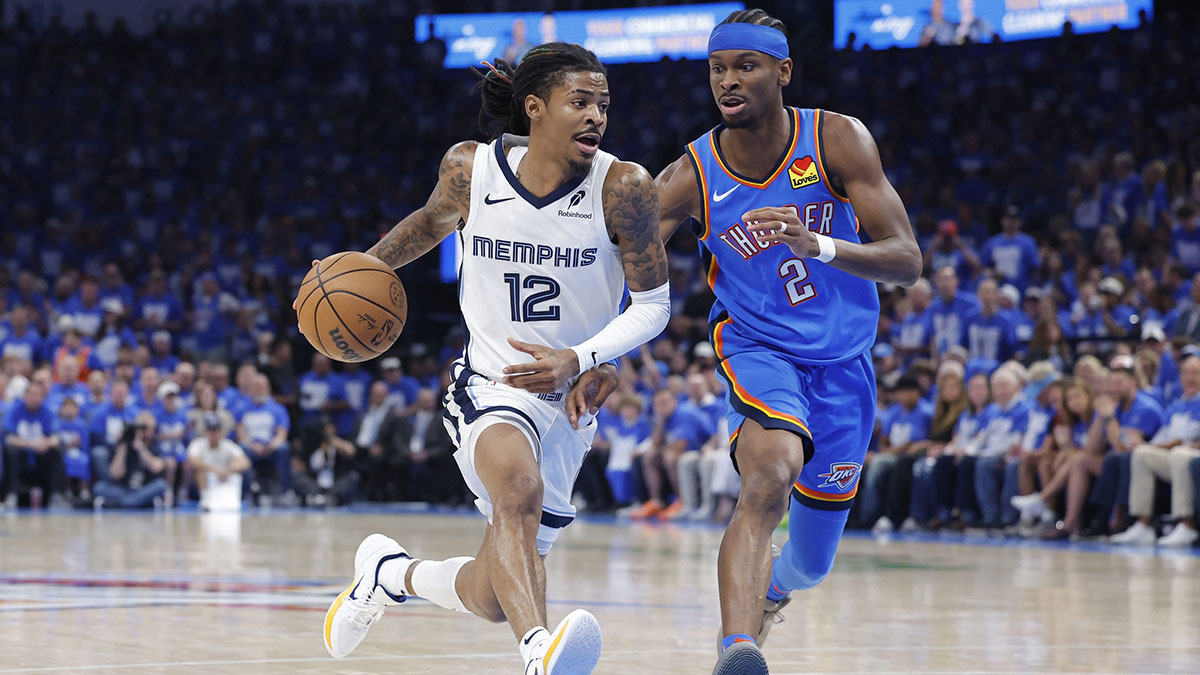 Memphis Grizzlies guard Ja Morant (12) drives to the basket beside Oklahoma City Thunder guard Shai Gilgeous-Alexander (2) in the third quarter during game two of first round for the 2024 NBA Playoffs at Paycom Center.
