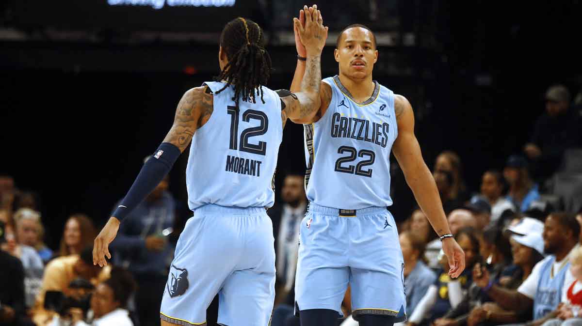 Memphis Grizzlies guard Desmond Bane (22) reacts with Memphis Grizzlies guard Ja Morant (12) during the first quarter against the Boston Celtics at FedExForum.