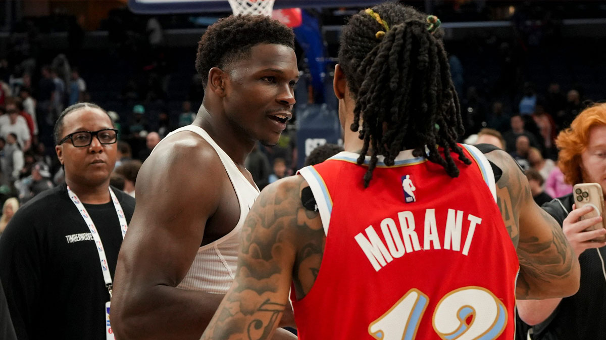 Timberwolves' Anthony Edwards (5) and Grizzlies' Ja Morant (12) hug after the Timberwolves defeated the Grizzlies 141-125 at FedExForum in Memphis, Tenn., on Thursday, April 10, 2025.