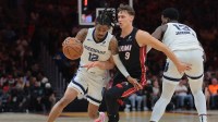 Memphis Grizzlies guard Ja Morant (12) drives to the basket past Miami Heat guard Pelle Larsson (9) during the second quarter at Kaseya Center.