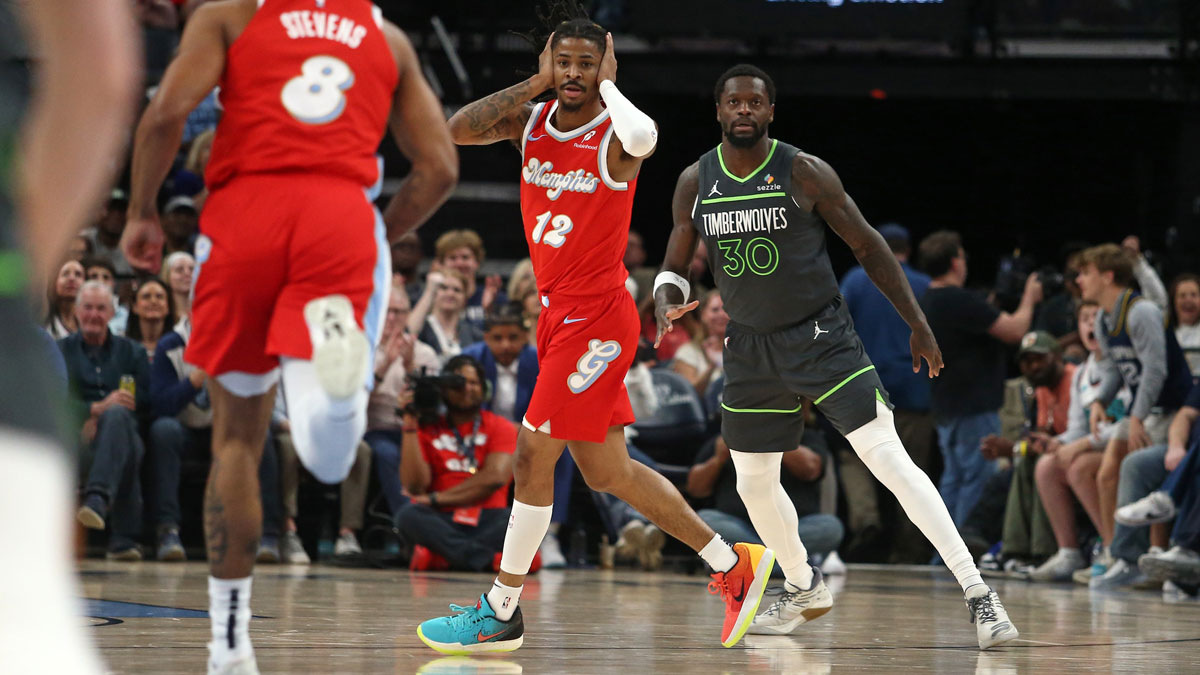Memphis Grizzlies guard Ja Morant (12) reacts after a three point basket during the first quarter against the Minnesota Timberwolves at FedExForum.