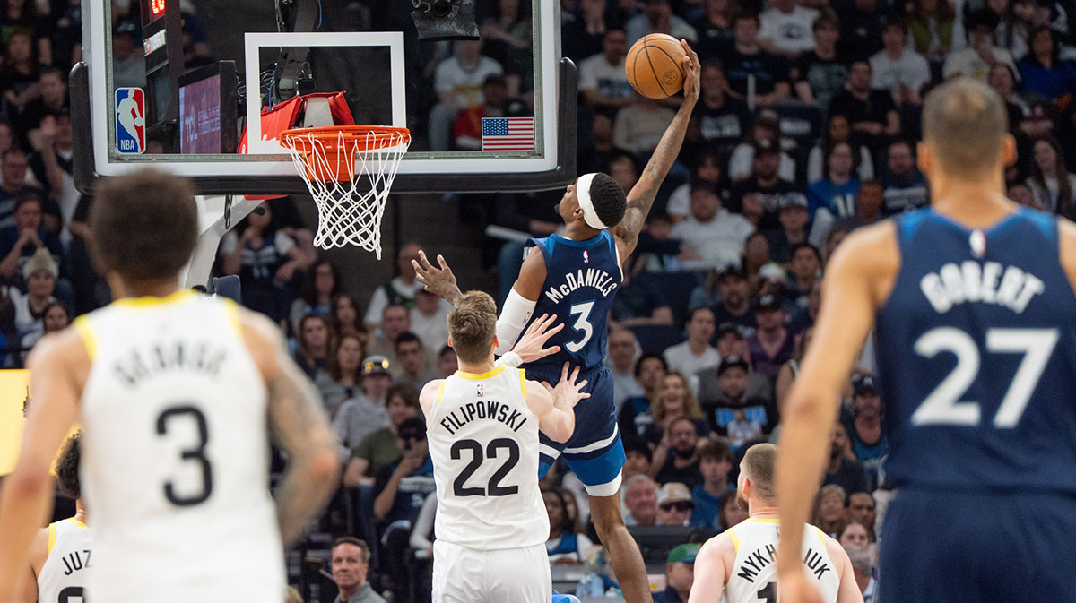 Minnesota Timberwolves forward Jaden McDaniels (3) dunks over Utah Jazz forward Kyle Filipowski (22) in the fourth quarter at Target Center.