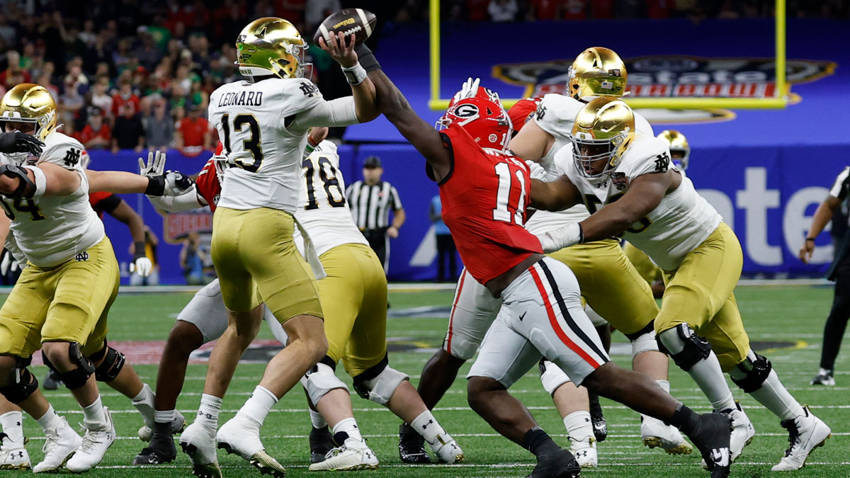 Notre Dame Fighting Irish quarterback Riley Leonard (13) passes the ball as Georgia Bulldogs linebacker Jalon Walker (11) defends during the first quarter at Caesars Superdome.