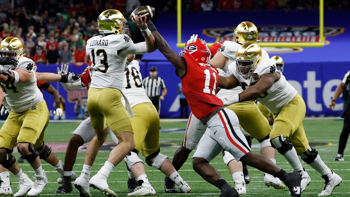 Notre Dame Fighting Irish quarterback Riley Leonard (13) passes the ball as Georgia Bulldogs linebacker Jalon Walker (11) defends during the first quarter at Caesars Superdome.