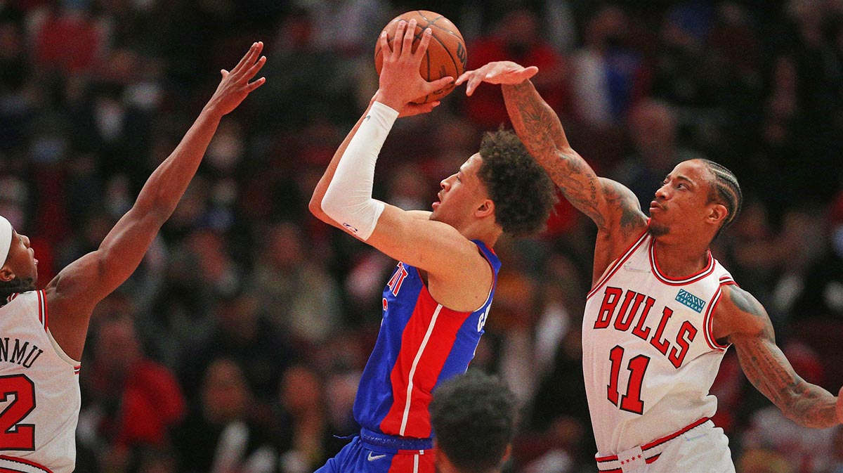 Jan 11, 2022; Chicago, Illinois, USA; Chicago Bulls forward DeMar DeRozan (11) attempts to block the shot of Detroit Pistons guard Cade Mandatory Credit: Dennis Wierzbicki-Imagn Images