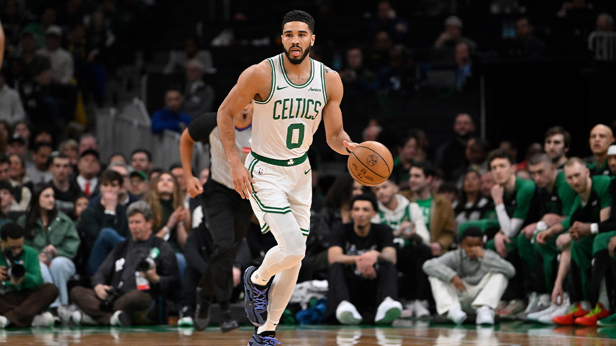 Boston Celtics forward Jayson Tatum (0) dribbles the ball against the Charlotte Hornets during the first half at TD Garden.